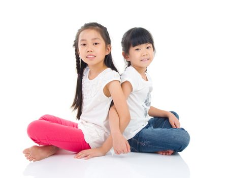 Asian sisters sitting on the floor 