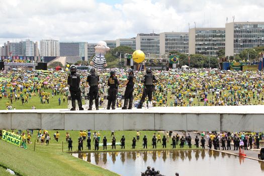 BRAZIL, Brasilia: Riot police officers stand in guard as thousands of anti-government protestors gather on the Praça dos Três Poderes (Three Powers Square), in Brasilia, during a demonstration calling for the removal of President Dilma Rousseff on March 13, 2016 . Demonstrations across the country today called for President Rousseff's exit amidst a massive corruption scandal and a deep economic recession. More than a million Brazilians have joined anti-government rallies across the country, ramping up the pressure on embattled president.