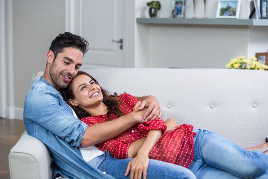 Romantic couple hugging while relaxing at home