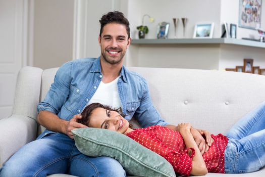 Portrait of romantic couple relaxing on sofa at home