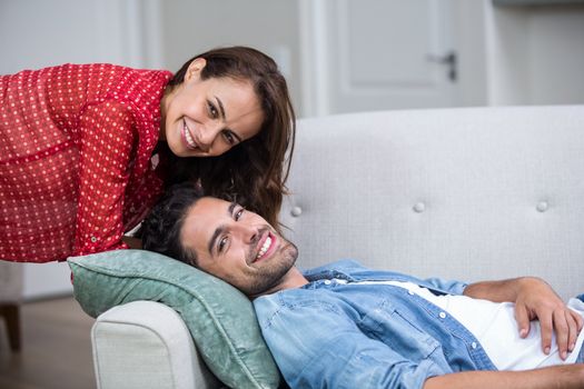 Portrait of happy romantic couple relaxing on sofa at home