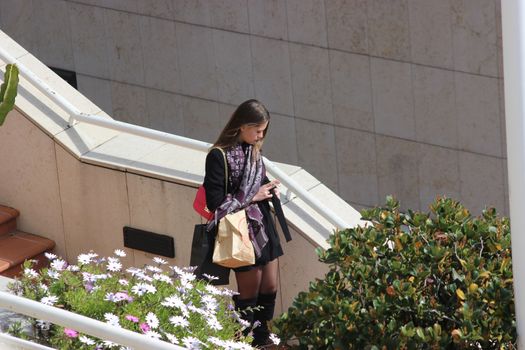 Monte-Carlo, Monaco - March 9, 2016: Fashionable Young Woman. Luxury Dressed Young Woman on the Street of Monte-Carlo, Monaco in the south of France