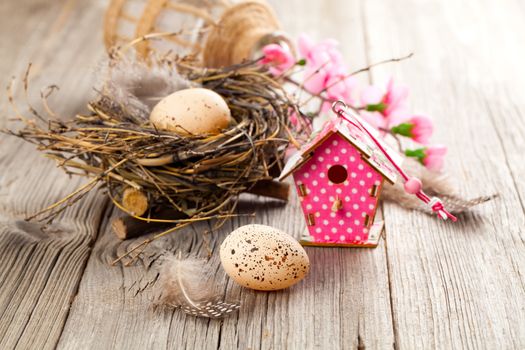 easter decoration on wooden background with color egg and with birdhouse
