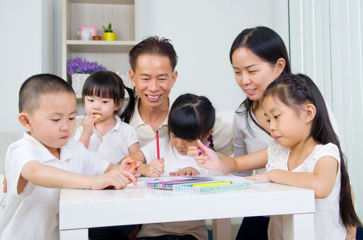 asian family doing school homework at living room