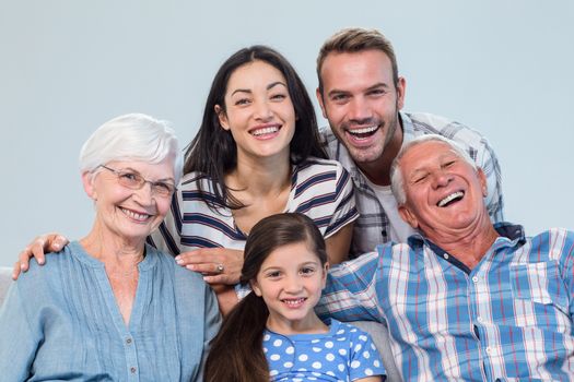 Happy family watching television sitting on a sofa in the living room 