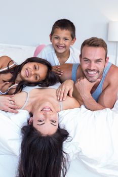 Happy family in their bedroom at home