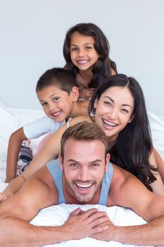 Happy family in their bedroom at home