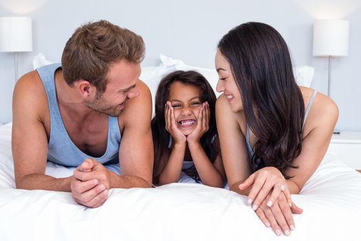 Happy family in their bedroom at home