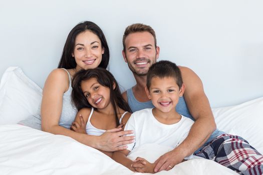 Happy family in their bedroom at home