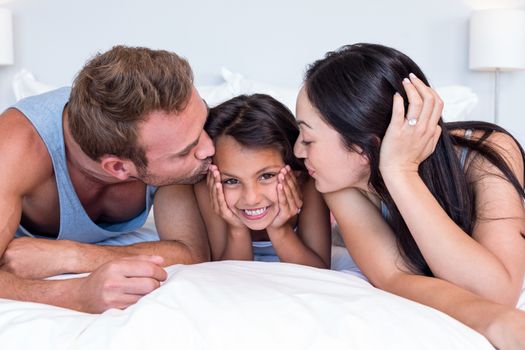 Happy family in their bedroom at home