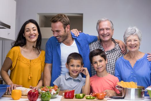 Portrait of happy family standing in the kitchen at home