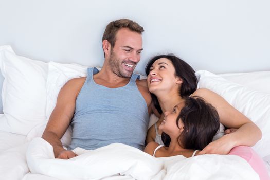 Happy family in their bedroom at home