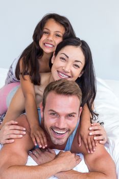 Happy family in their bedroom at home