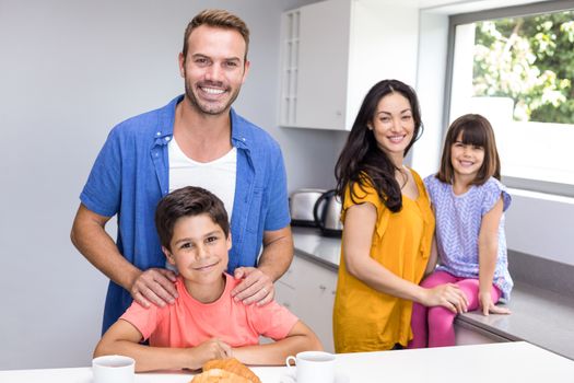 Happy family in the kitchen having breakfast