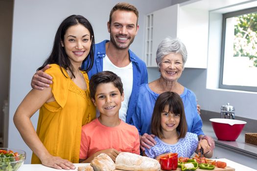 Happy family in the kitchen chopping vegetables at home