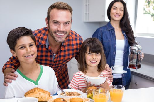 Happy family in the kitchen having breakfast