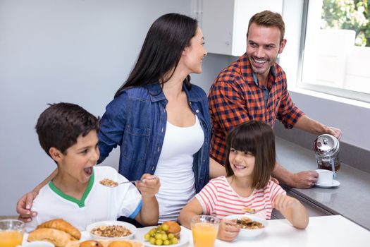 Happy family in the kitchen having breakfast