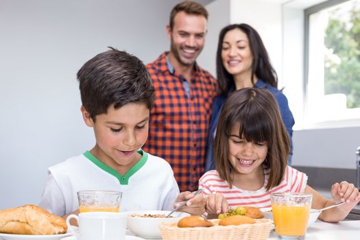 Happy family in the kitchen having breakfast