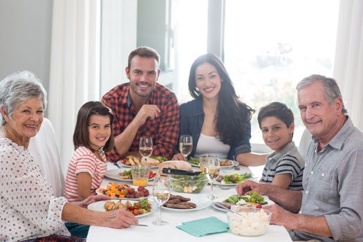 Family sitting at dining table having meal