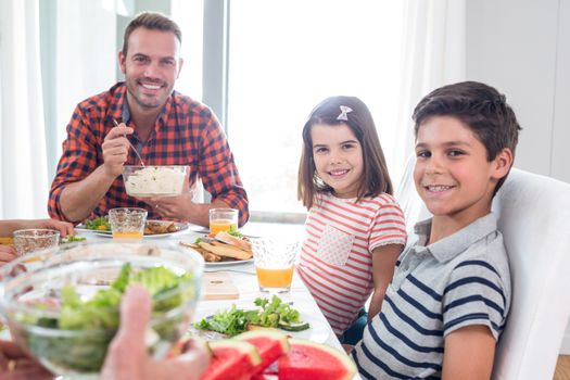 Happy family having breakfast in the morning