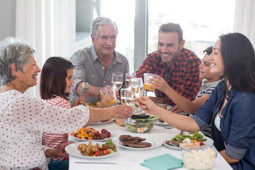 Family sitting at dining table having meal