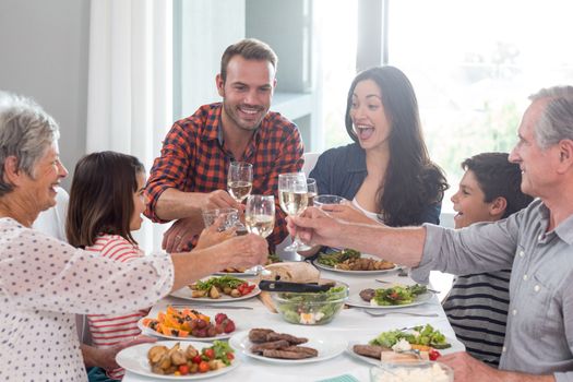 Family sitting at dining table having meal