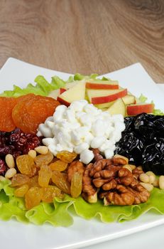 salad with nuts, apples, dried fruit and cottage cheese in lettuce leaves