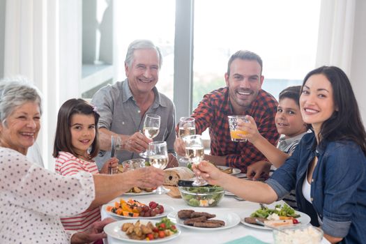 Family sitting at dining table having meal