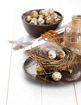 table decoration on white wooden background with quail eggs