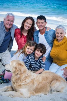 Happy family with their dog at the beach on a sunny day