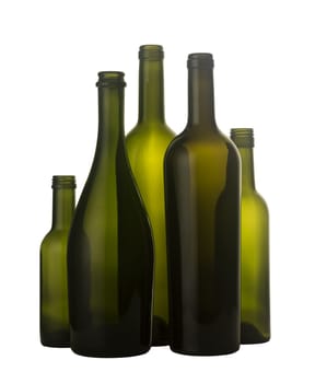 Vertical front view of a group of empty wine bottles of different sizes, shapes and colorisolated on white background.