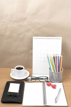 office desk : coffee with phone,wallet,calendar,color pencil box,notepad,heart on wood background