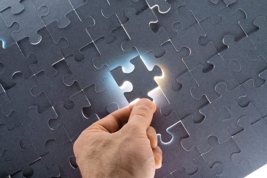 Man putting puzzle piece, close up view