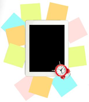 Alarm clock with set of stickers and tablet on white