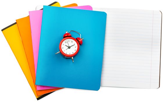 Set of notebooks with alarm clock on isolated white background, closeup