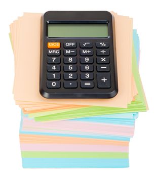 Calculator on stack of colorful stickers on isolated white background