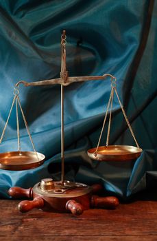 Closeup of old brass weight scales on green cloth background