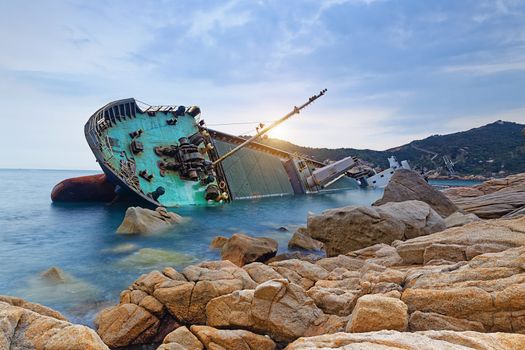 shipwreck or wrecked cargo ship abandoned on sea bay