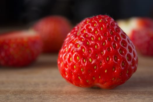 red ripe  fresh strawberries on wooden table