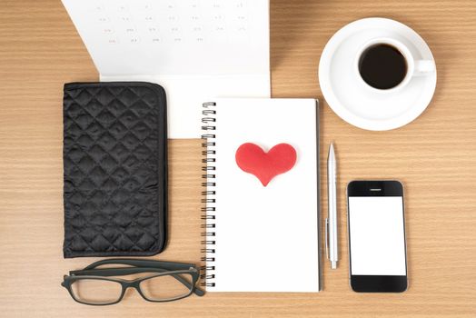 office desk : coffee with phone,wallet,calendar,heart,notepad,eyeglasses,heart on wood background