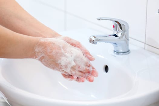 Washing of hands with soap under running water. Hygiene and Cleaning Hands.