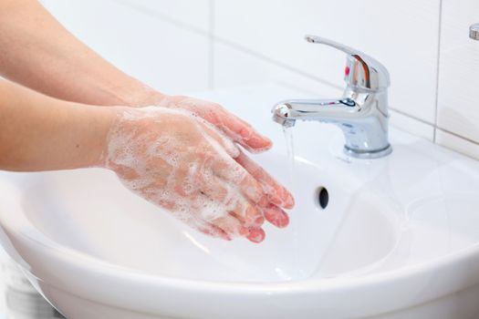 Washing of hands with soap under running water. Hygiene and Cleaning Hands.