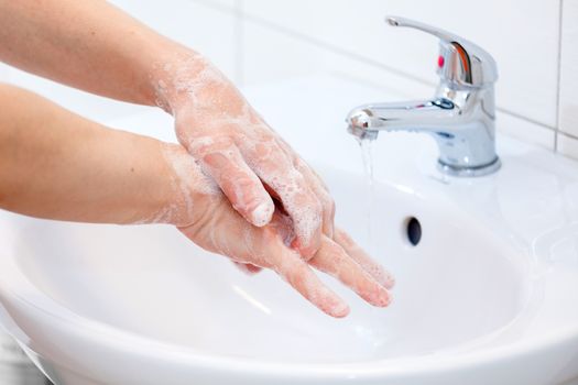 Washing of hands with soap under running water. Hygiene and Cleaning Hands.