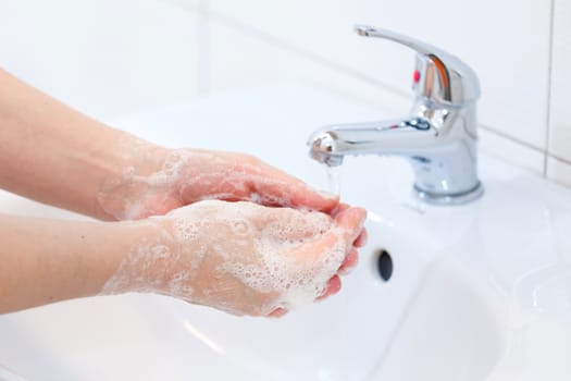 Washing of hands with soap under running water. Hygiene and Cleaning Hands.