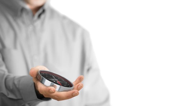 Caucasian man holding a compass, copy space on the right side of the image. Orientation or guidance background concept over white.