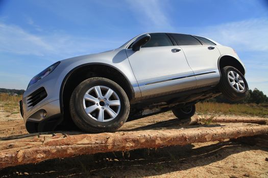 test drive of SUV car with obstacles on field