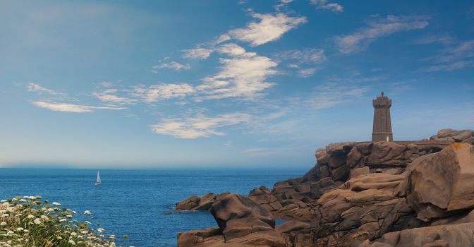 Men ruz lighthouse in Brittany France between Ploumanach and Perros Guirec pink granit coast landscape, Blue sky 