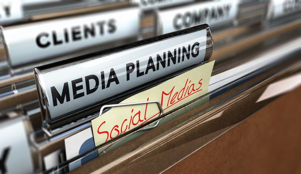 Close up on a file tab with the text media planning plus a note where it is handwritten social medias Blur effect. Concept image for illustration of communication or advertising agency