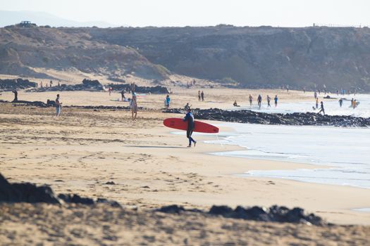 EL Cotillo, Spain - Dec 17, 2015:  Active sporty people having fun learning to surf on El Cotillo beach, famous surfing destination on Fuerteventura, Canary Islands, Spain on December 17, 2015. 