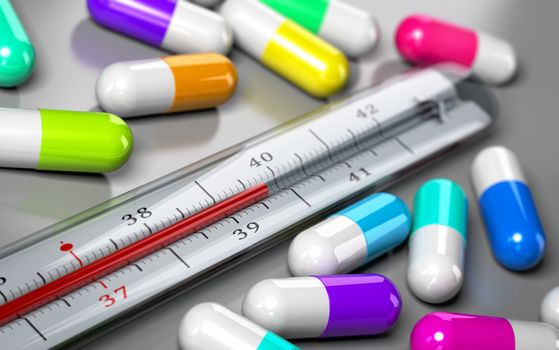 thermometer with many pills around it over grey background. Concept image for illustration of over consumption of drugs and antibiotics.